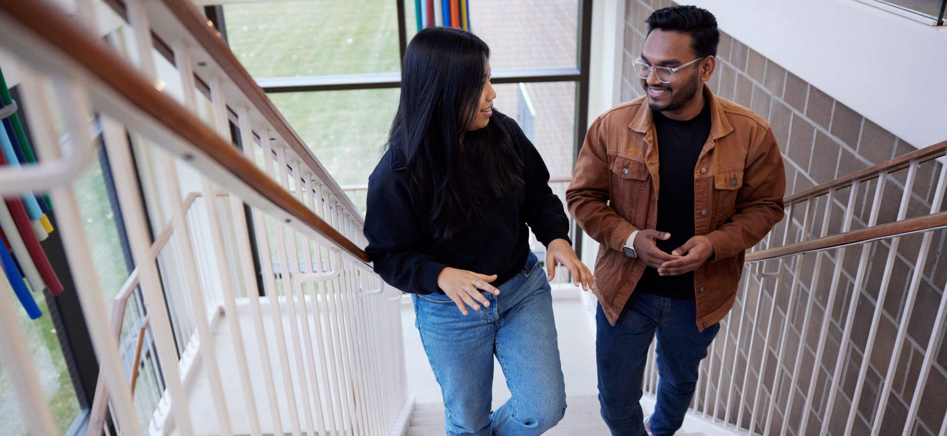 Students walking up the campus stairs.